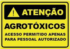Placa amarela com o texto "Atenção: Agrotóxicos. Acesso permitido apenas para pessoal autorizado."